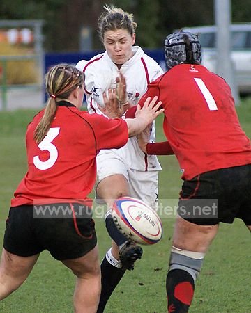 Rachael Burford squeezes one ethrough the Welsh defence