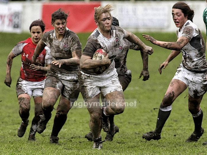 Cath Spencer leads the England pack out of the mudbath at Crosskeys