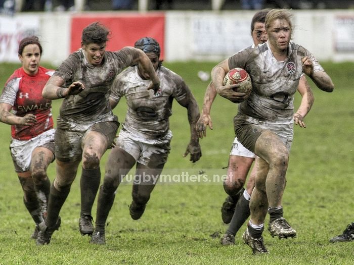 Cath Spencer leads the England pack out of the mudbath at Crosskeys