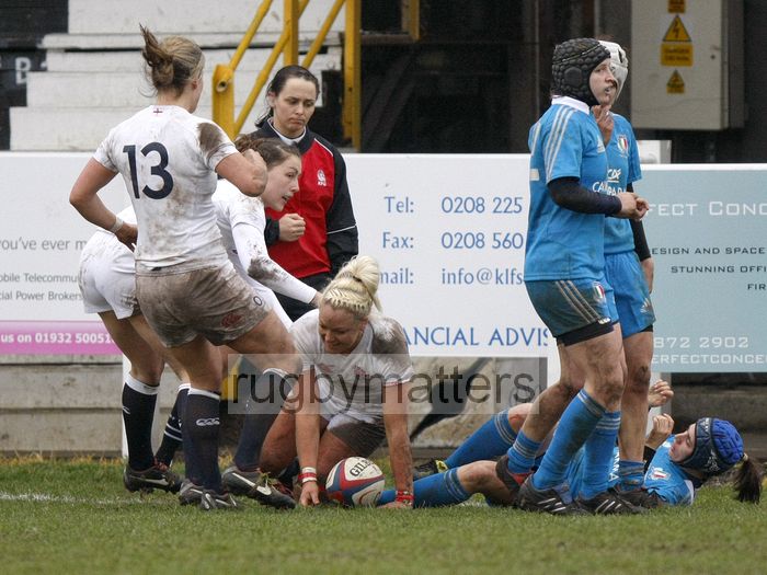 Sally Tuson smiles as she gets up and her team mates come to congratulate her on scoring a try. England Women v Italy Women at Esher RFC, Moseley Road, Hersham, Surrey on 9th March 2013, KO 1300.
