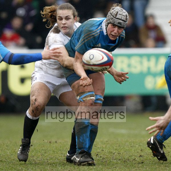 Silvia Gaudino tackled by Fiona Davidson as she passes the ball from the back of a scrum. England Women v Italy Women at Esher RFC, Moseley Road, Hersham, Surrey on 9th March 2013, KO 1300.