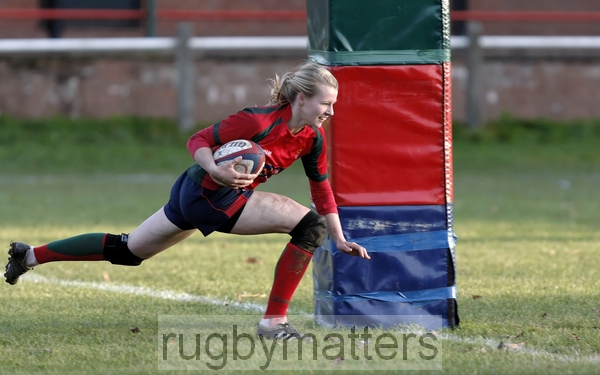 Rose Jay smiles as she dives between the posts to score a try.