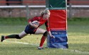 Rose Jay smiles as she dives between the posts to score a try.