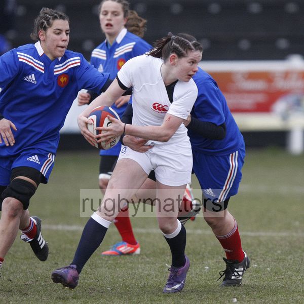 Leanne Riley looks to offload the ball while being tackled. U20 England Women v U20 France Women at Esher RFC, Molesey Road, Hersham, Surrey. 23rd February 2013, KO 1400.