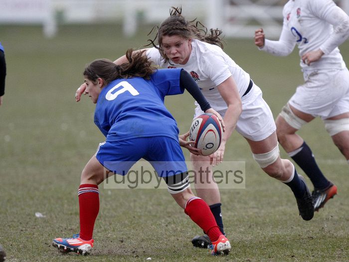 Marie Menanteau passes the ball as Abbie Scott comes in for the tackle. U20 England Women v U20 France Women at Esher RFC, Molesey Road, Hersham, Surrey. 23rd February 2013, KO 1400.