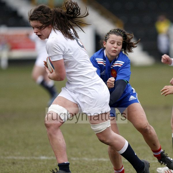 Abbie Scott crashes through a tackle and then goes on to score a try.U20 England Women v U20 France Women at Esher RFC, Molesey Road, Hersham, Surrey. 23rd February 2013, KO 1400.