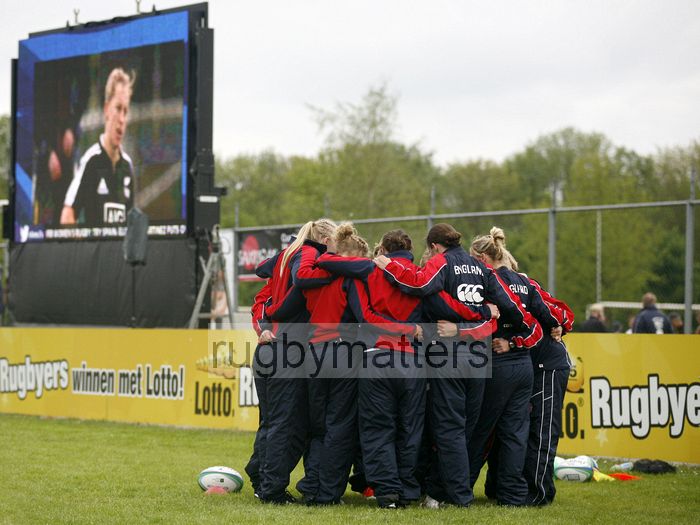 England have a pre-match huddle, Kelly Brazier appears to look on from the big screen. IRB Women's Sevens World Series at Amsterdam Sevens, National Rugby Centre, Amsterdam, 18th May 2013